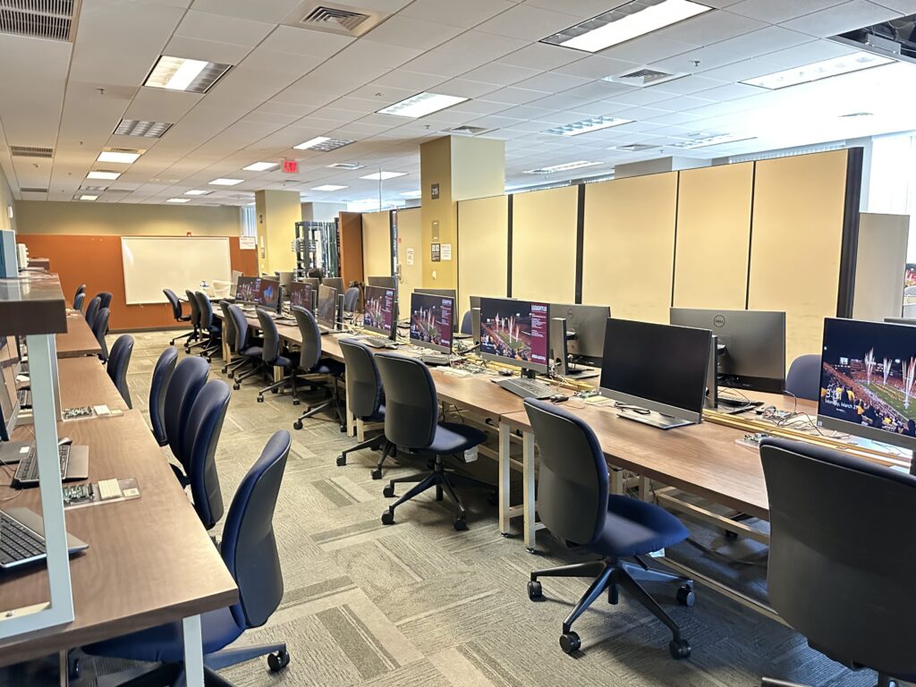 A computer lab belonging to the Ira A. Fulton Schools of Engineering. Shown is another angle of the same room, showing three rows of computers which are each hooked up to a breadboard.